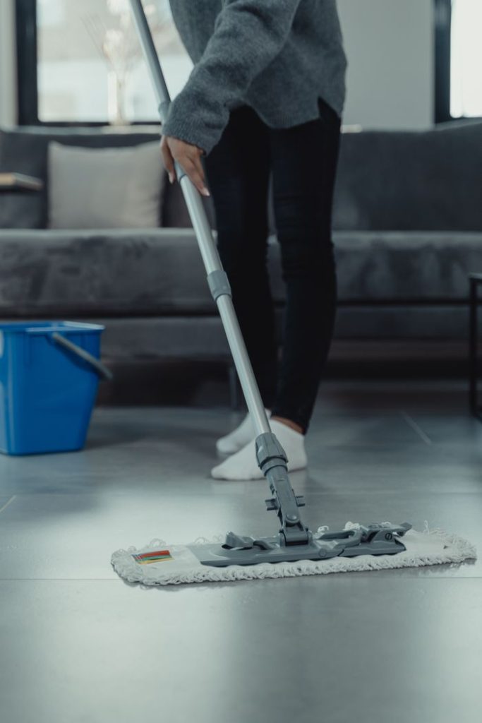The Art of Drawing Readers In: Your attractive post title goes here Close-up of person mopping a clean tile floor in a contemporary living room.